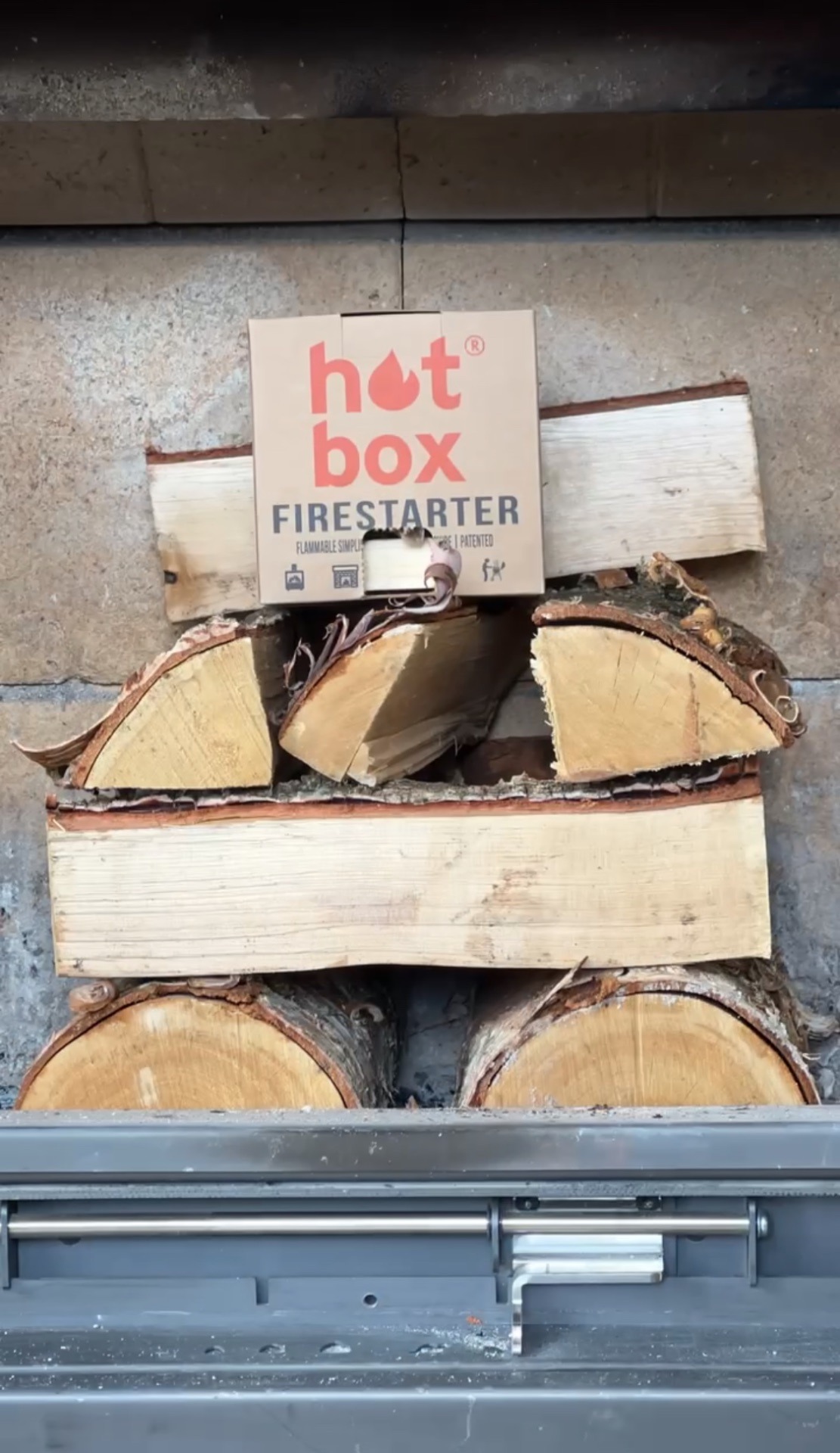 hot box firestarter on top of stacked logs - hotboxfirestarter.com